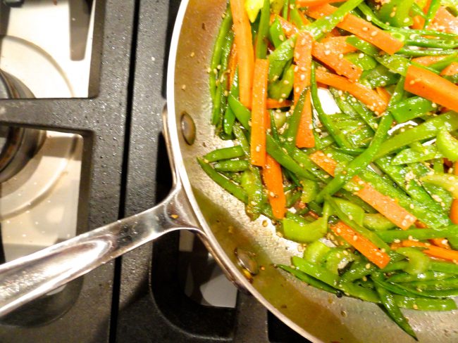 Carrot Snow Pea and Celery Stir Fry in a fry pan.
