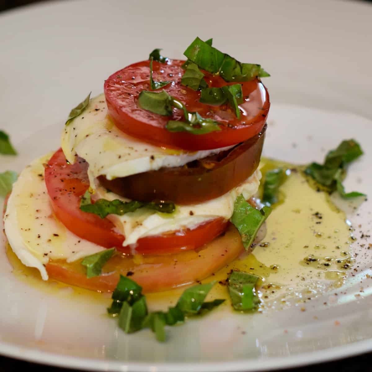 Colorful tomatoes, mozzarella cheese, basil, and fruity olive oil combined to make this Classic Caprese Salad.