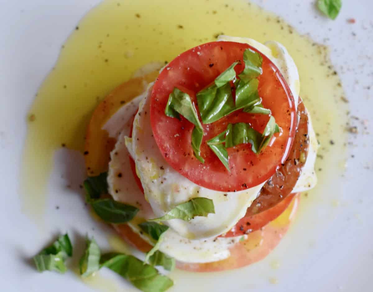 A classic overview of a caprese salad with extra virgin olive oil.