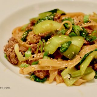 Chinese Style Noodles with Ground Lamb and Bok Choy served in a white bowl
