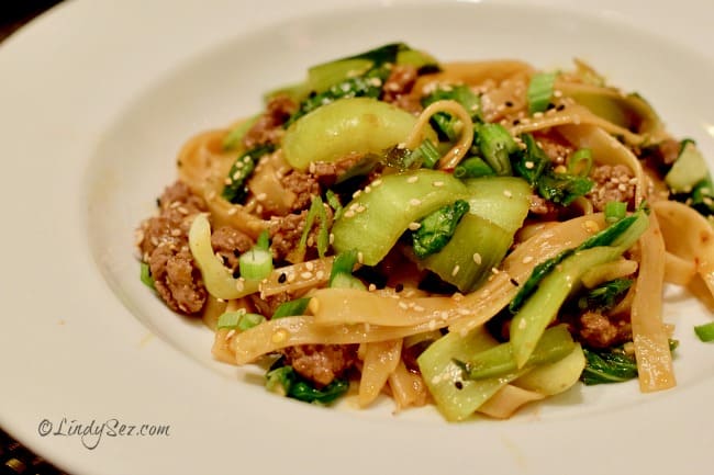 Chinese Style Noodles with Ground Lamb and Bok Choy served in a white bowl