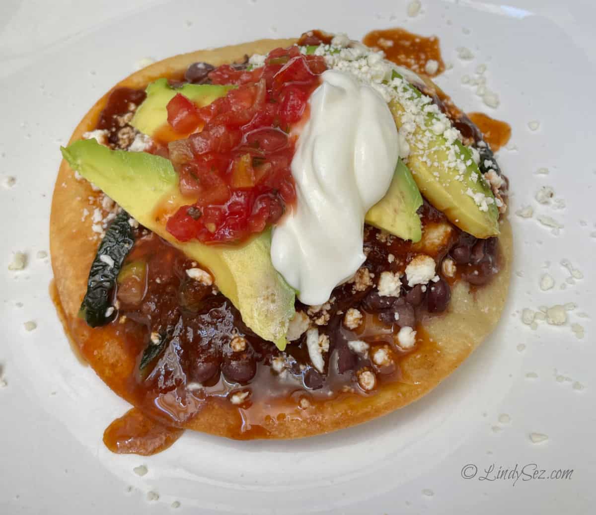A plate of Huevos Rancheros with all the toppings.
