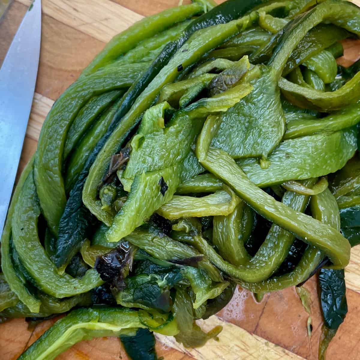 A pile of sliced peeled and cleaned poblano peppers.