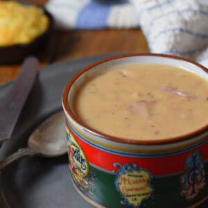 A hot bowl of soup with cornbread.