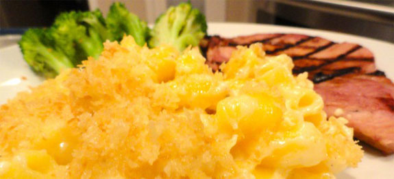 Lindy's Favorite Macaroni and Cheese with steamed broccoli and smoked pork chop on a plate.