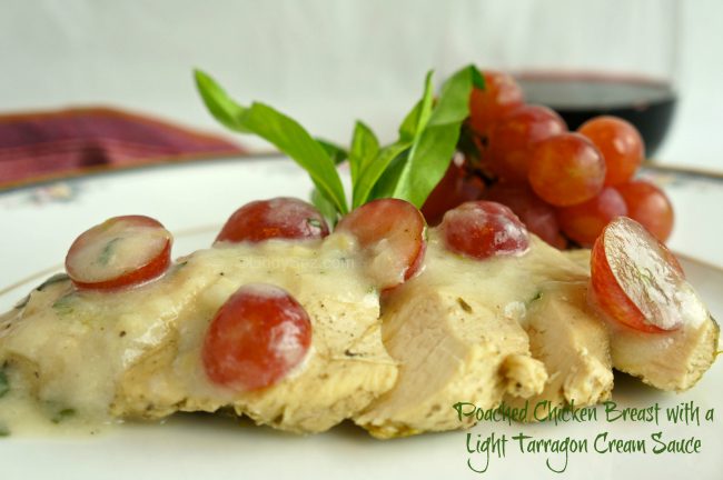 Poached Chicken Breast with a Light Tarragon Cream Sauce on a plate with garnishes.
