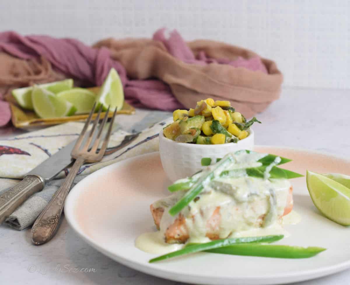 A plate of salmon with a jalalpeno cream sauce.
