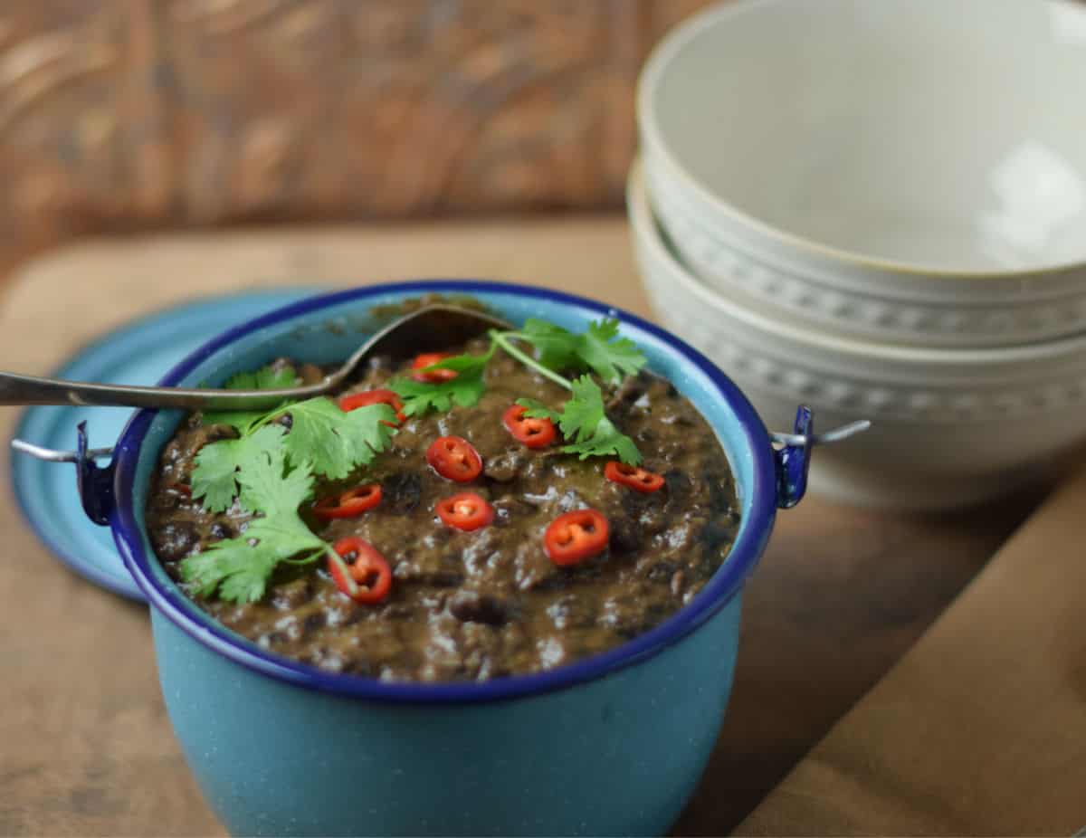 Savory Black Beans with white bowls.