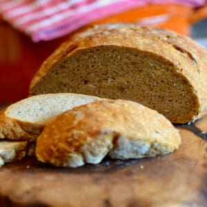 A sliced loaf of quick no knead crusty rye bread.