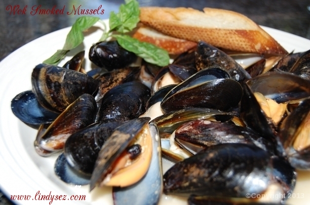 Crostini on a white bowl with Wok Smoked Mussels.