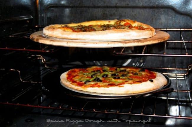 Two perfect pizzas in the oven baking.