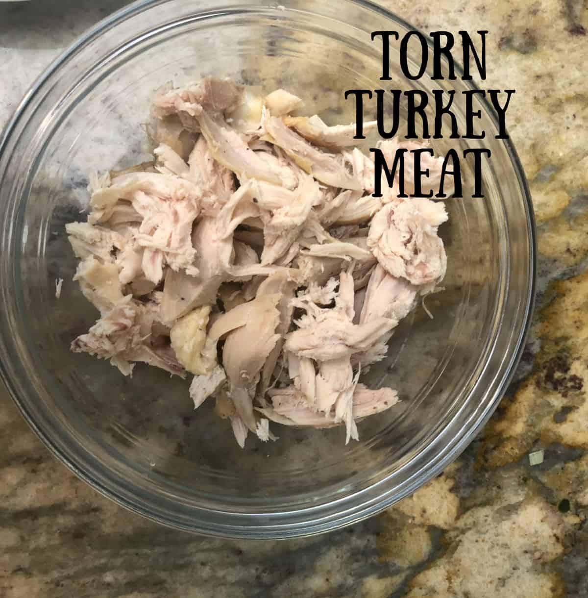 A bowl of torn turkey meat.