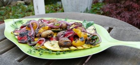 Grilled Summer Vegetables with Herb Dressing on a green platter.