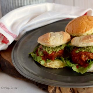 Meatball Slider on a platter with a white towel in the background.