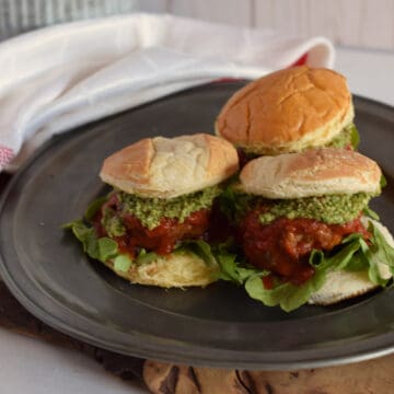 3 Italian Meatball Sliders on a pewter plate.