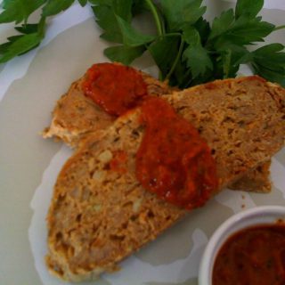 A serving of Turkey Meatloaf with Roasted Tomato and Red Pepper Sauce.