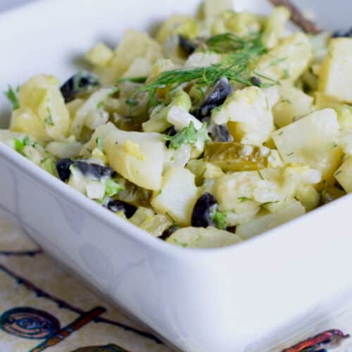 The perfect Old-Fashioned Potato salad with fresh herbs in a bowl.