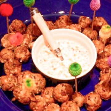 Greek-meatballs on a plate with yogurt sauce.