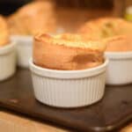 A fluffy Yorkshire pudding in a white ramikin.
