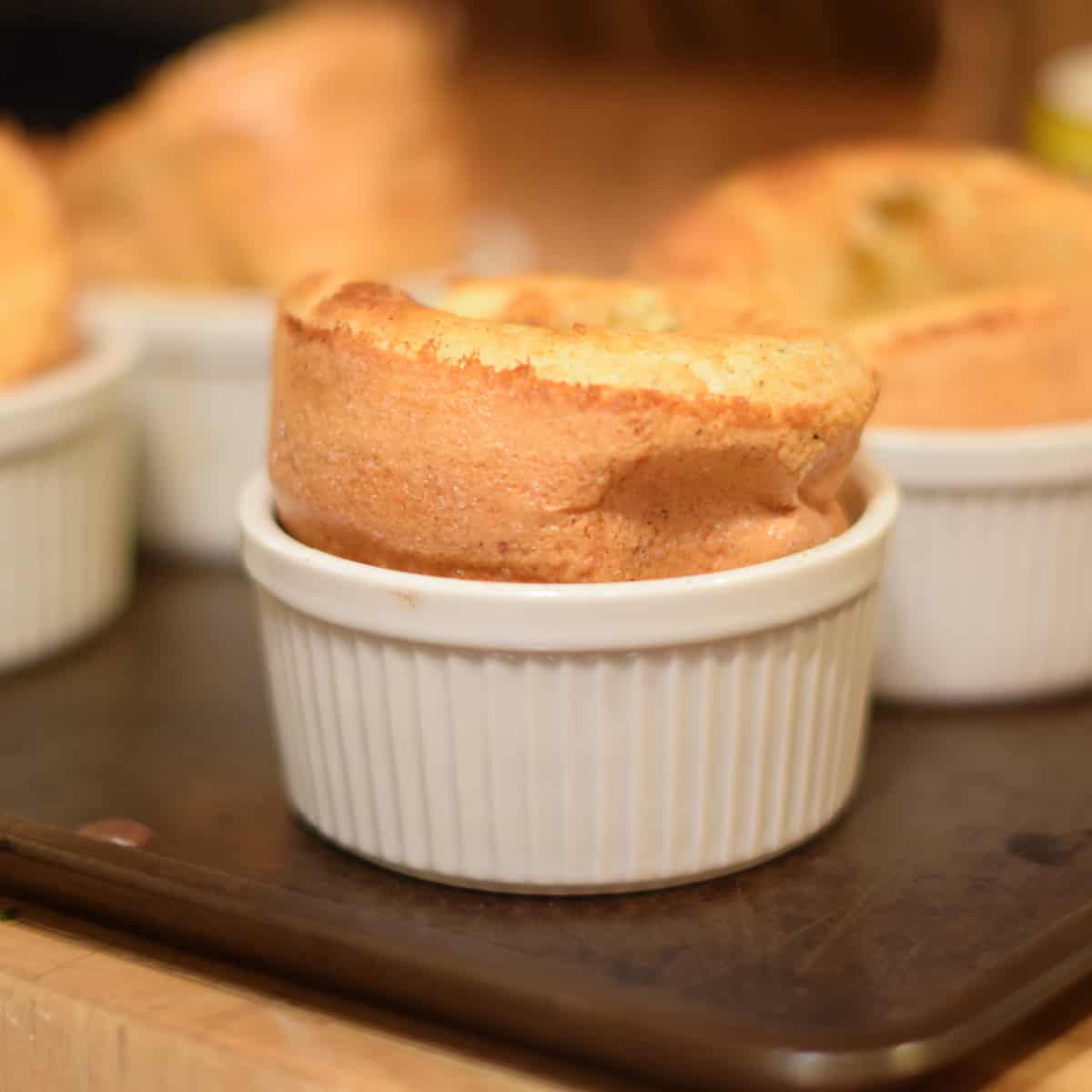 A fluffy Yorkshire pudding in a white ramikin.