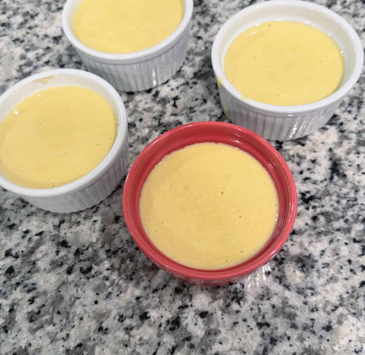 4 dishes of creme brulee made from sweet summer corn, cream, and milk.