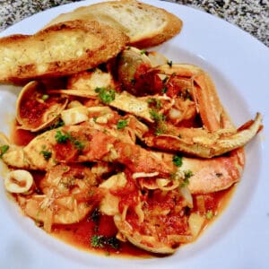 A white bowl filled with Cioppino.