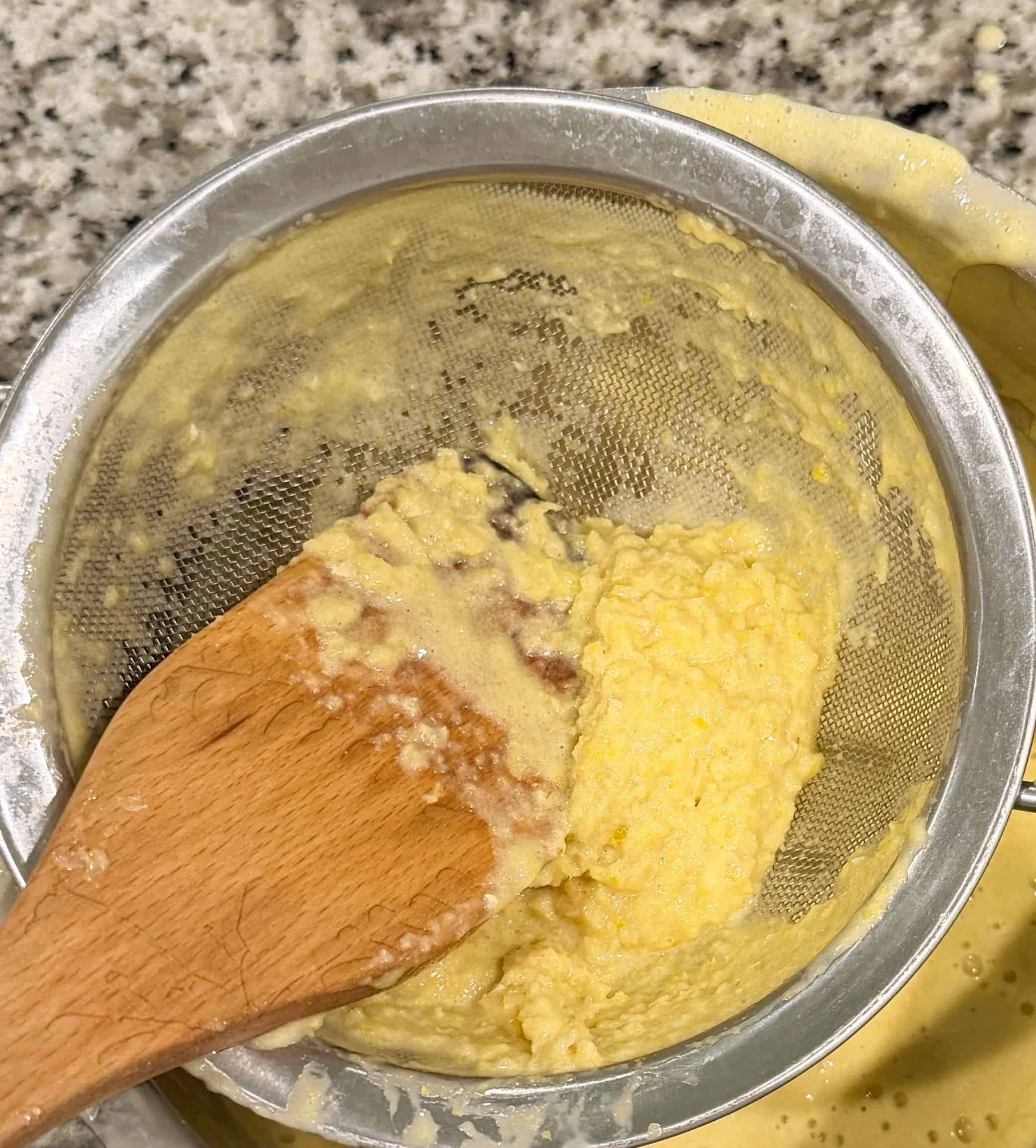 Corn pulp left in a mesh strainer.