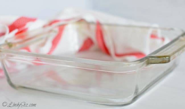 A pyrex baking dish to be used for making cornmeal muffins.
