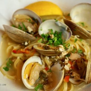 clam spaghetti close up in bowl with juicy juice