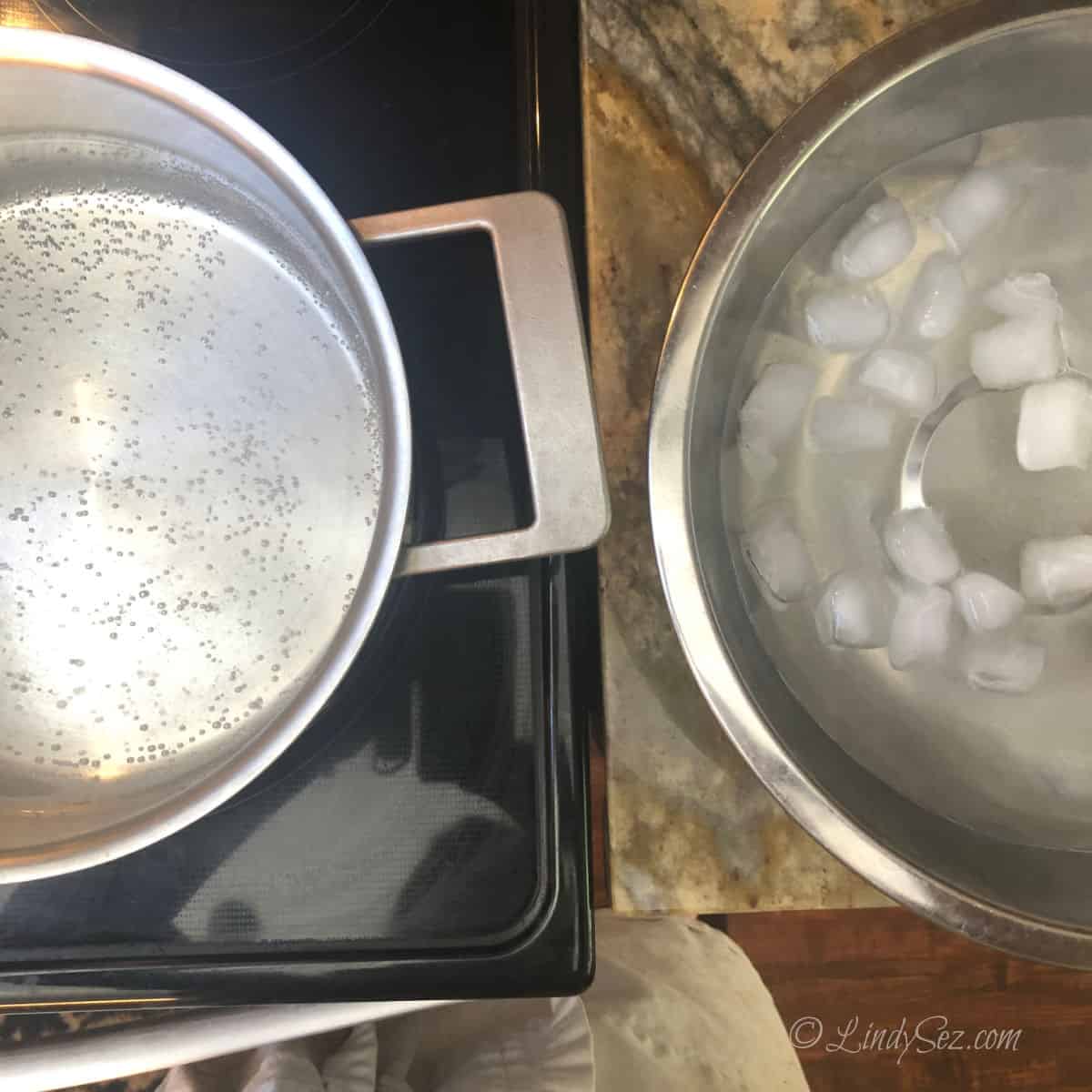 A hot pot of water next to an ice bath to be used to easily peel the peaches.
