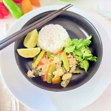 Thai Minced Chicken Stir-fry with rice in a black bowl.