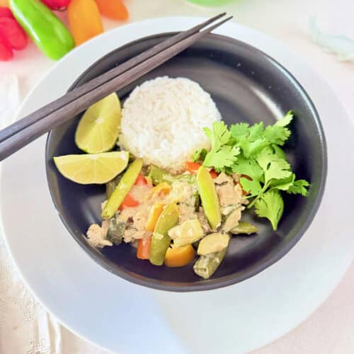 Thai Minced Chicken Stir-fry with rice in a black bowl.