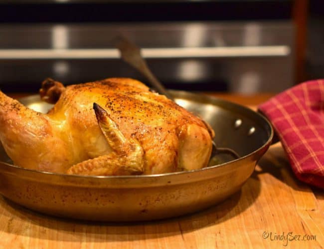 Perfect simple roast chicken in a suate pan to demonstrate the cooking method.