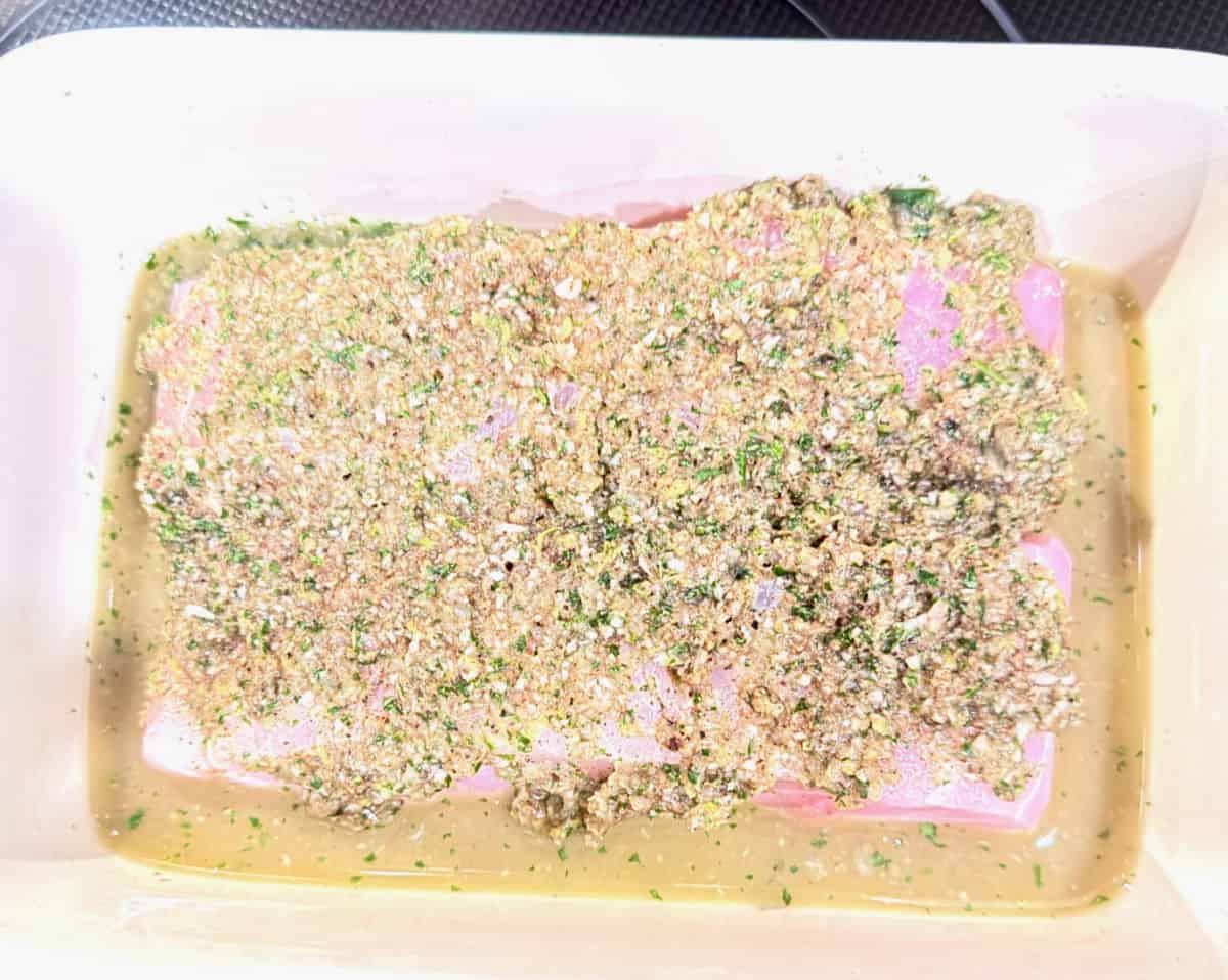Chermoula White Fish being marinated in a baking dish.