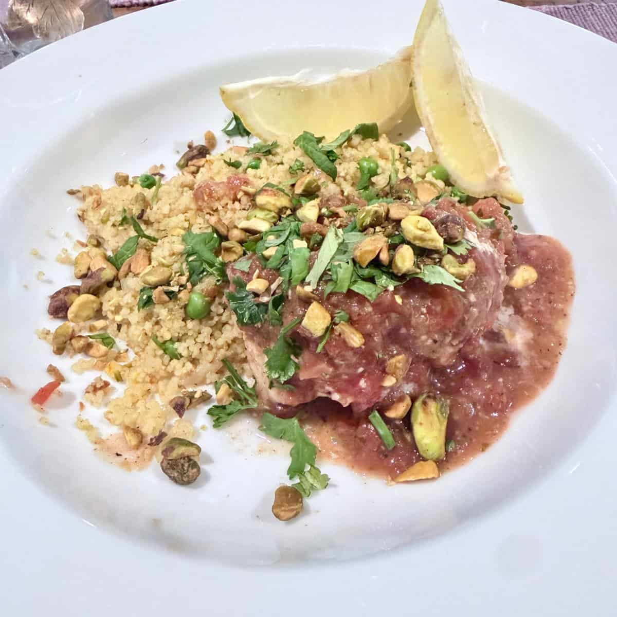 A place with Churmoula baked whitefish along side some couscous.