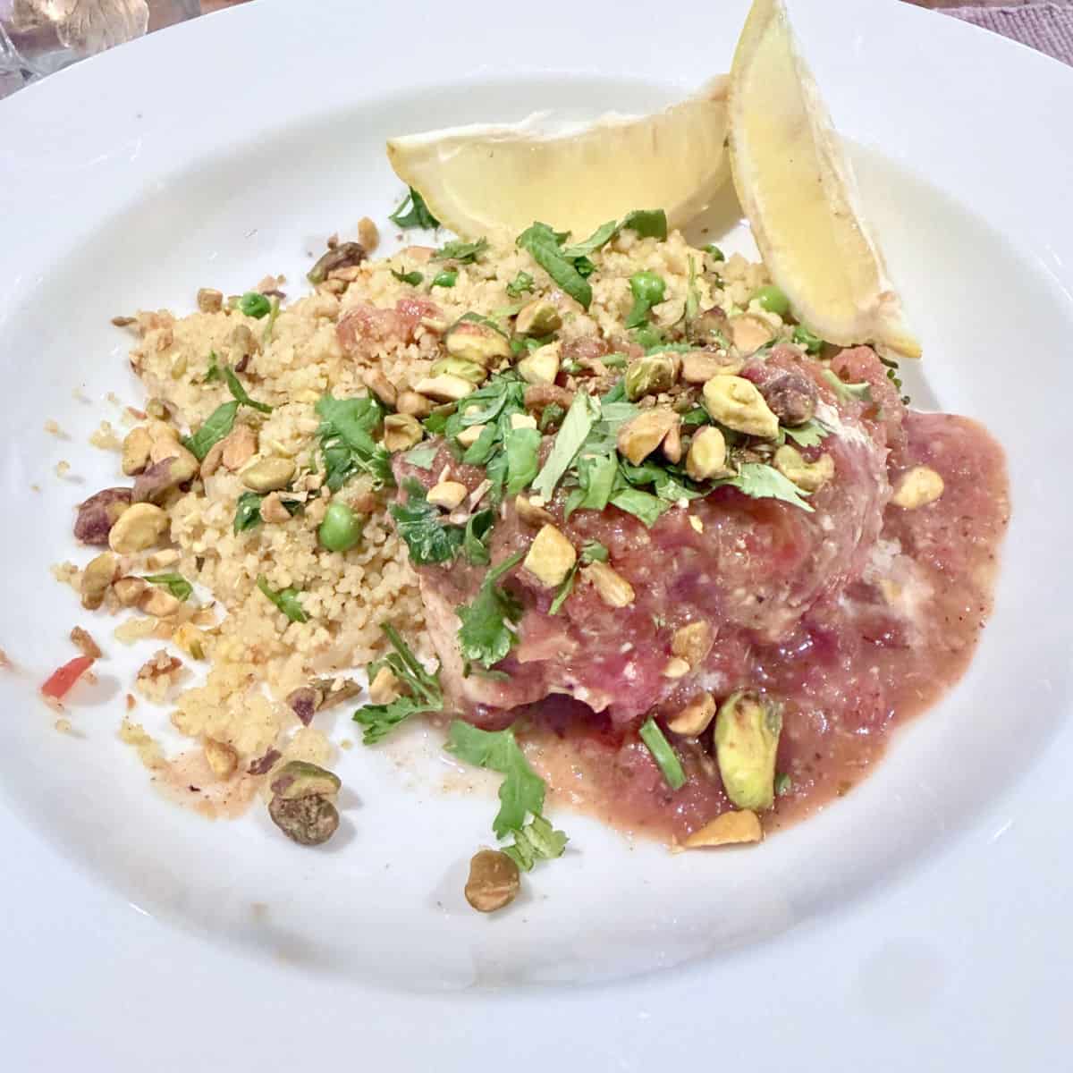Moroccan White Fish with couscous on a white dish.