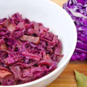 Bright red German Sweet and Sour Red Cabbage in a white bowl.