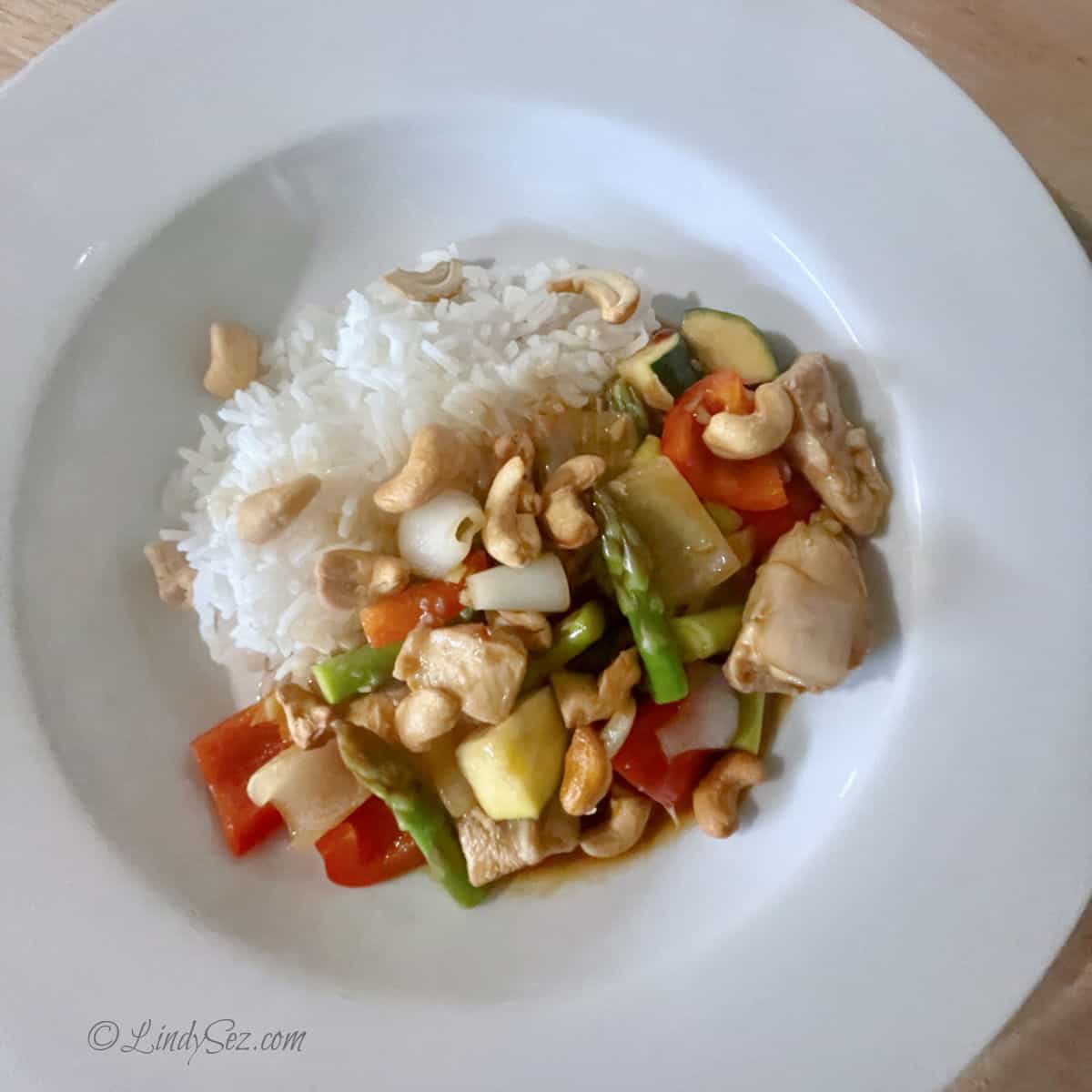 A large white bowl with spicy chicken stir fry.