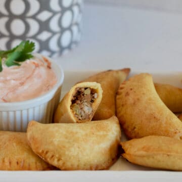 Pork Picadillo Empanadas, ready to dip into a little creamy salsa.