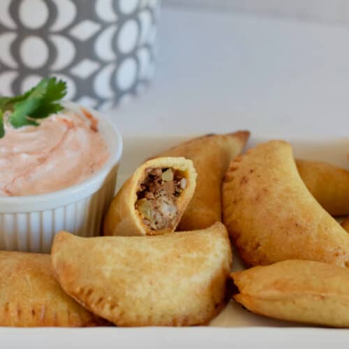 Pork Picadillo Empanadas, ready to dip into a little creamy salsa.