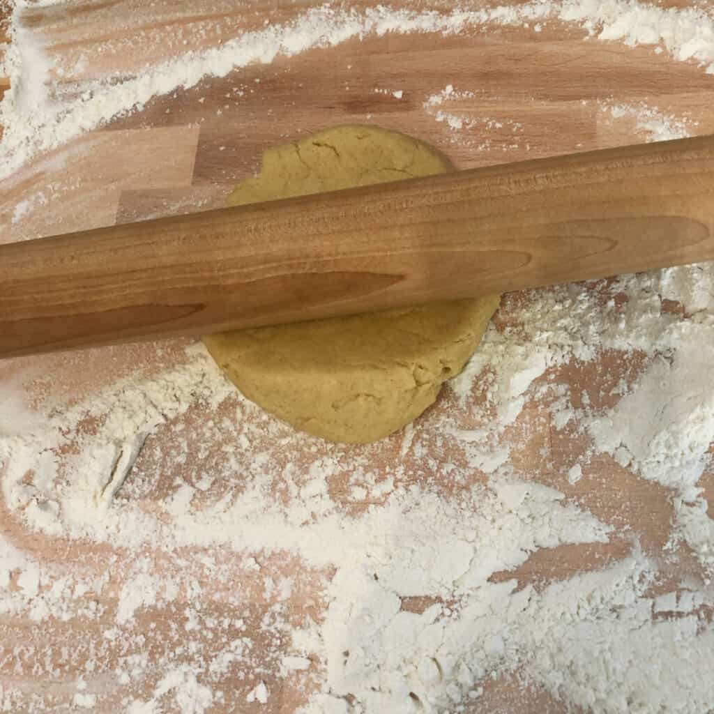 Rolling out the dough on a floured board.