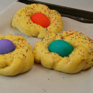 Colorful eggs on unbaked Easter Bread.