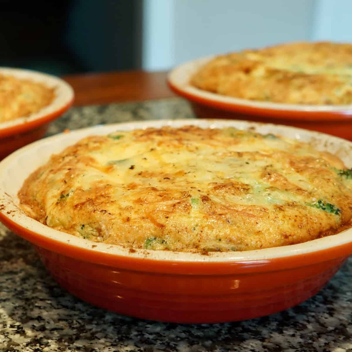 Crustless blue cheese and leek quiches in small baking dishes.
