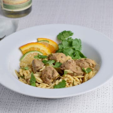 Citrus Tequila Sunrise Pork in a bowl with orzo and cilantro.