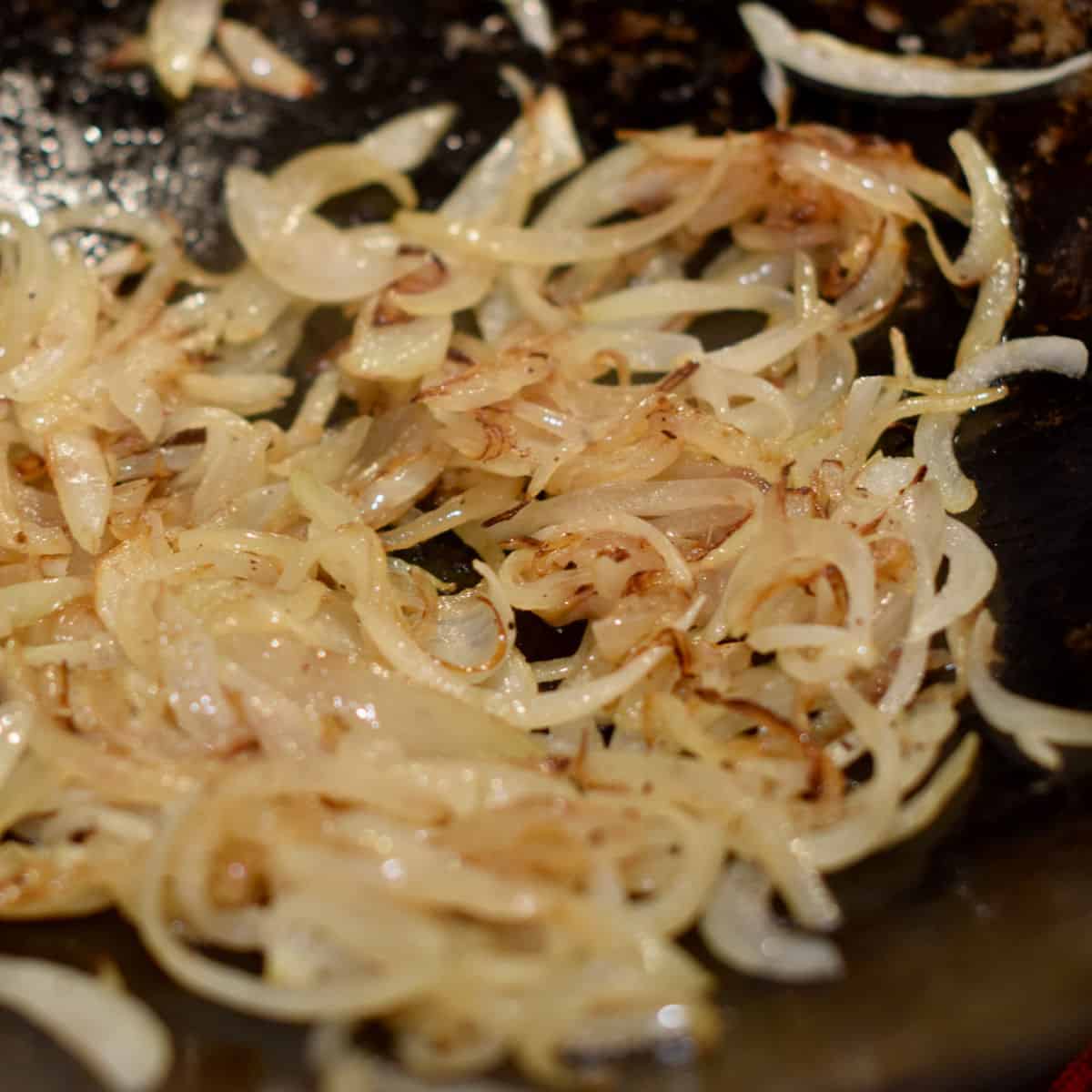 Onions in a pan with nicely browned edges.