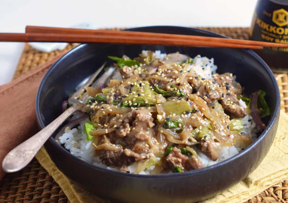 A black bowl of Easy Five-Spice Beefy Rice Bowl with Bok Choy.