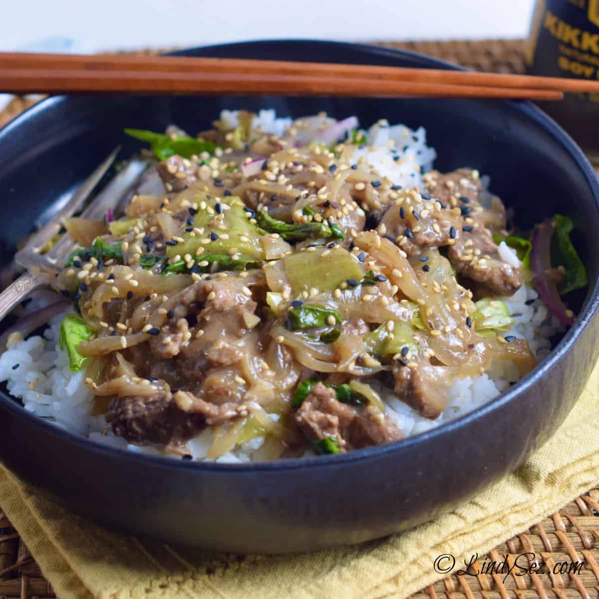 A bowl of easy five-spice beefy rice bowl with bok choy.