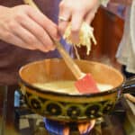 Making a cheese fondue.