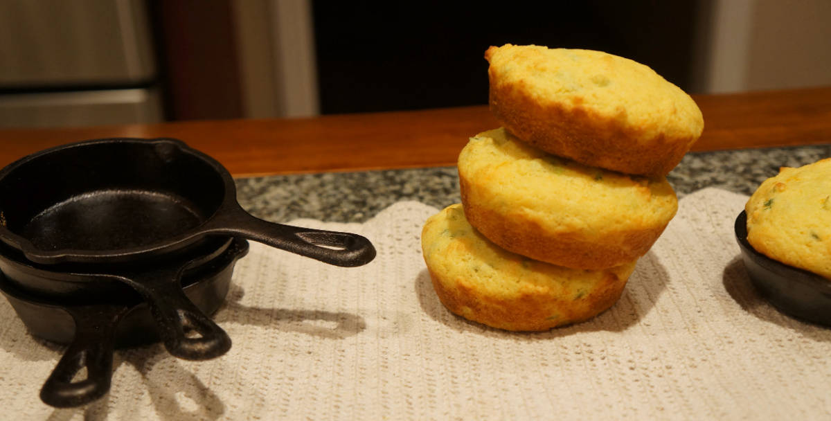 Mini skillets with a side of corn muffins.