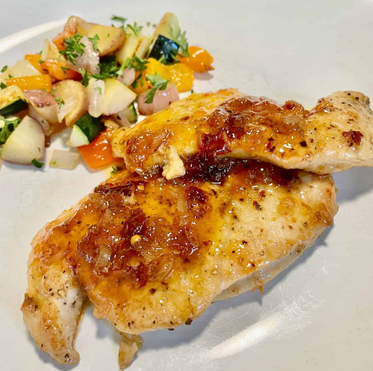 The finished dish for a quick easy sweet spicy apricot chipotle glazed turkey cutlet.